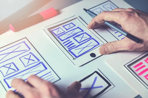 Ux graphic designer sketching wireframe for mobile app and websi — Stock Photo, Image