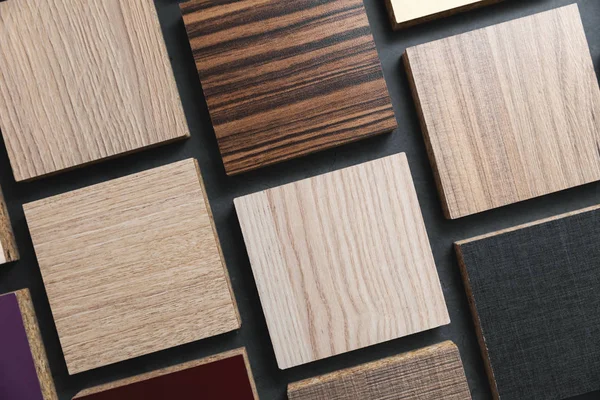 Laminate material samples on dark black background — Stock Photo, Image