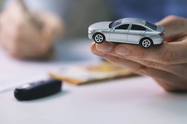 Buy new car concept - signing contract in dealer office — Stock Photo, Image