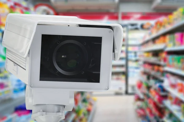 Cctv camera or security camera on retail shop blurred background — Stock Photo, Image