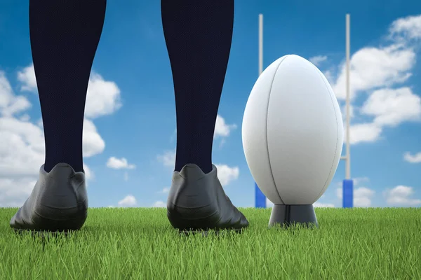 rugby ball with rugby posts on field