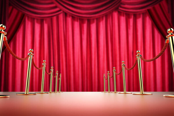 красный ковер и веревочный барьер на фоне красного занавеса
