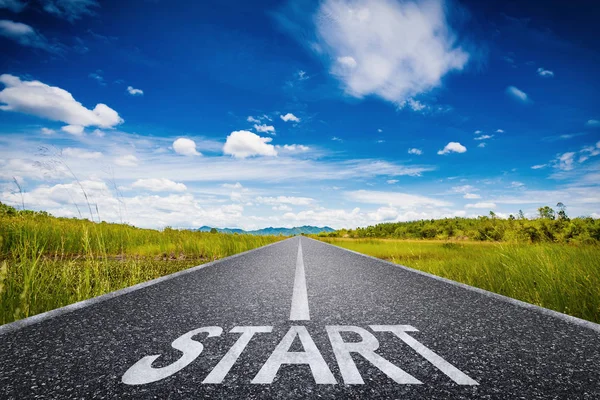 Start text on long road with green field and blue sky — Stock Photo, Image