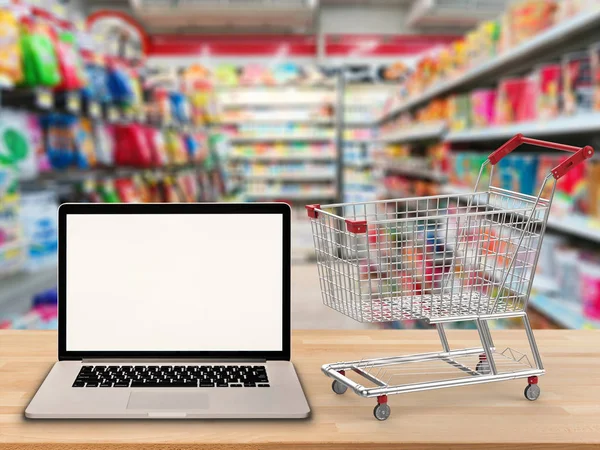 Blank screen notebook with shopping cart — Stock Photo, Image