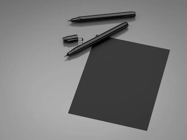 Papel em branco preto com canetas pretas — Fotografia de Stock