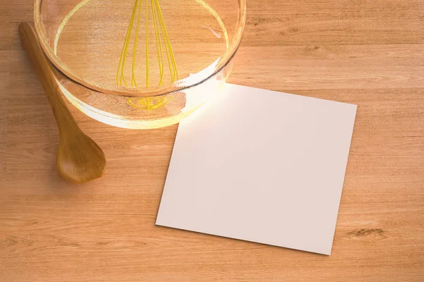 Blank paper with wire whisk in a bowl — Stock Photo, Image