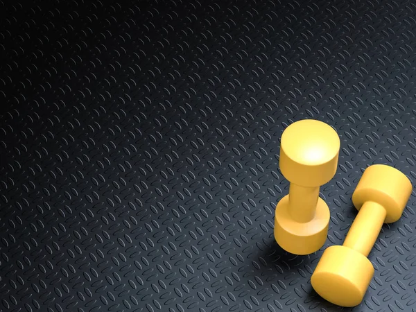Жовті гантелі на чорному килимку йоги — стокове фото