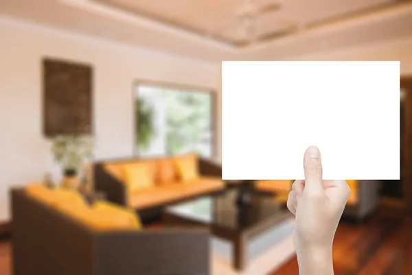 Mano sosteniendo papel en blanco con fondo interior — Foto de Stock