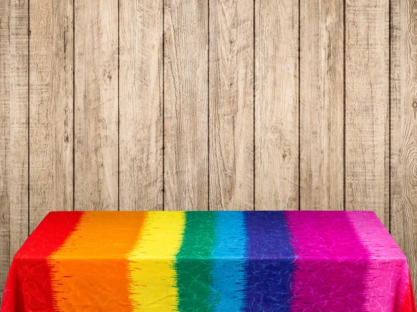 Rainbow tablecloth on wooden background — Stock Photo, Image