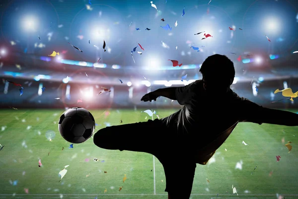 Silhouette soccer player kicking the ball — Stock Photo, Image