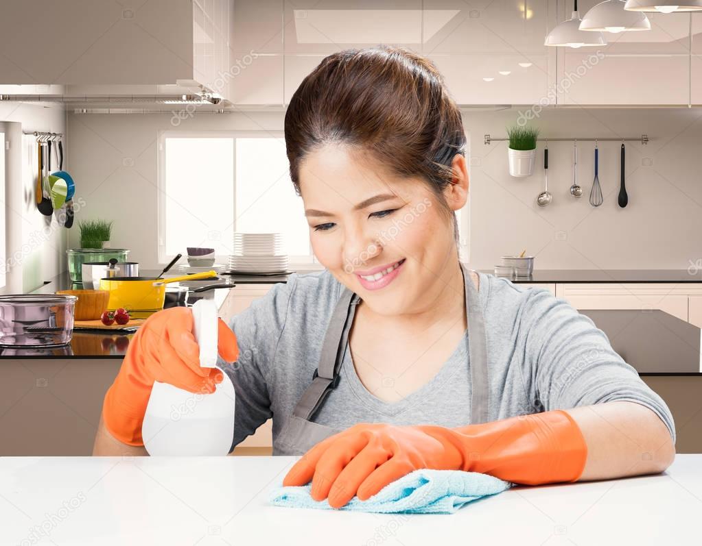 asian housekeeper cleaning on table