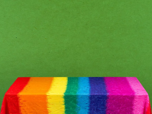 Rainbow tablecloth on green background — Stock Photo, Image