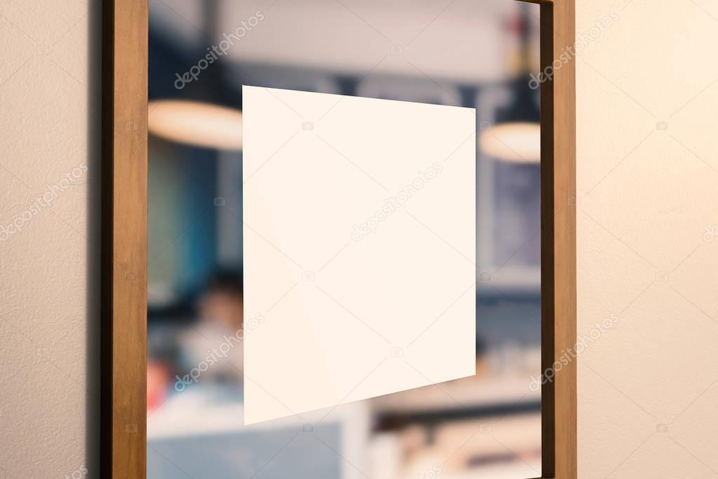 blank square sign on glass door 