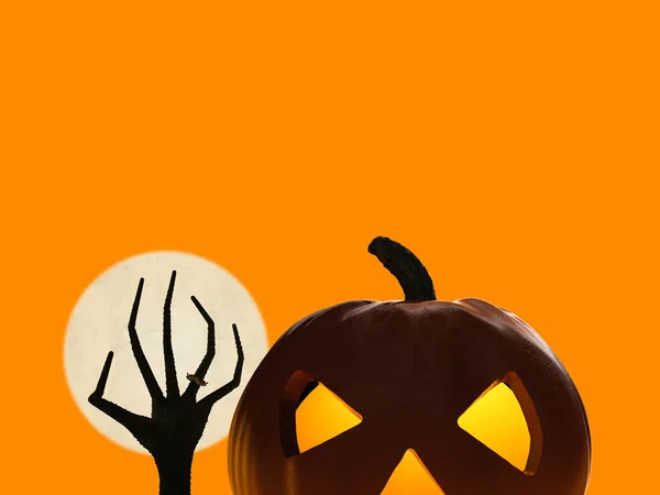 Halloween pumpkin and zombie hand rising — Stock Photo, Image