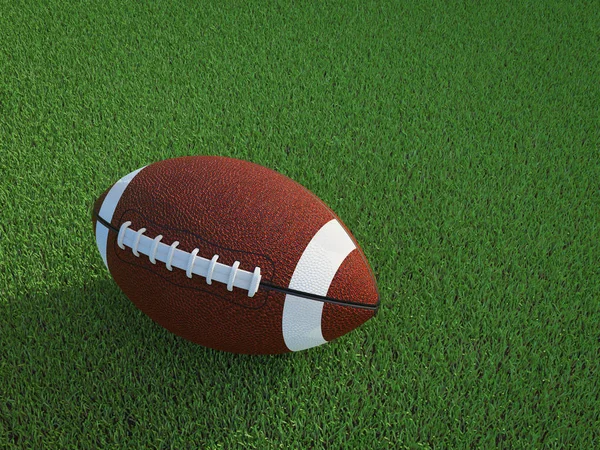 Американский футбольный мяч на поле — стоковое фото