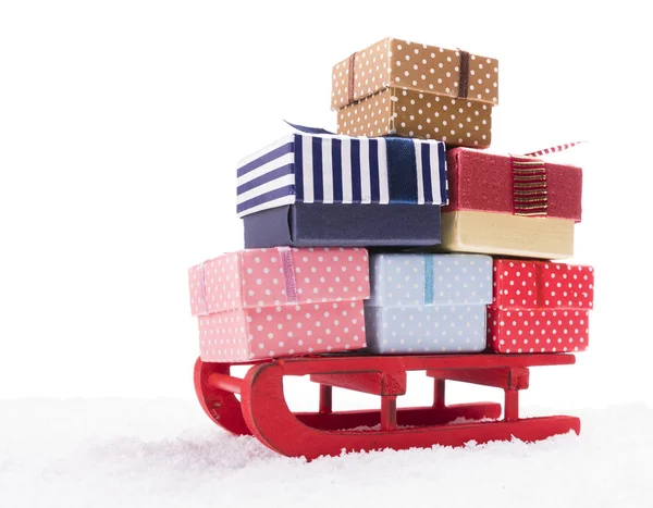Wooden sled full of gift boxes — Stock Photo, Image