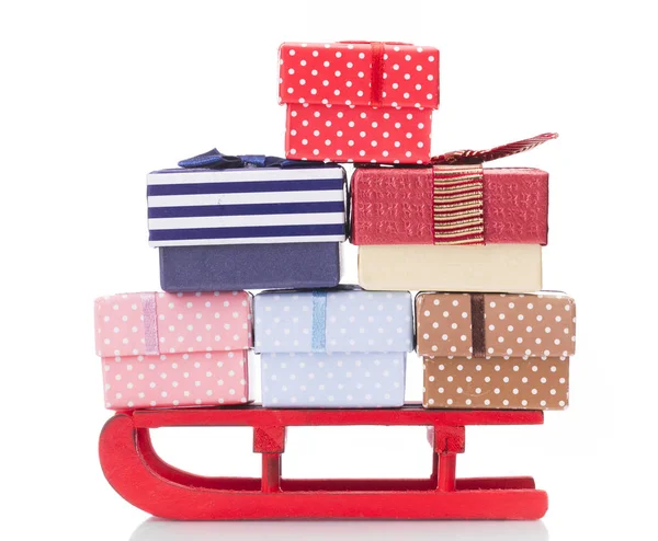 Closeup of a red sled full of gift boxes — Stock Photo, Image