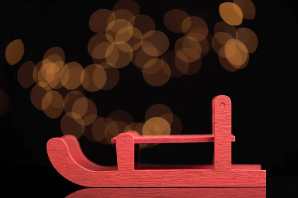 Red sled on bokeh background — Stock Photo, Image