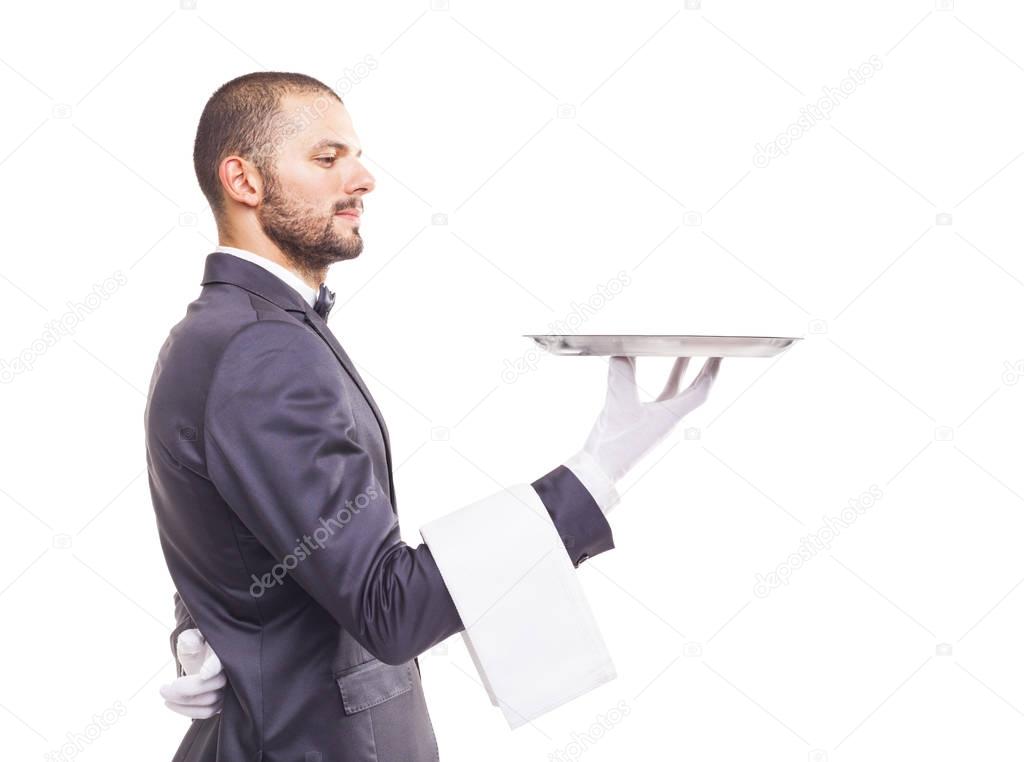 waiter in tuxedo and gloves holding empty tray