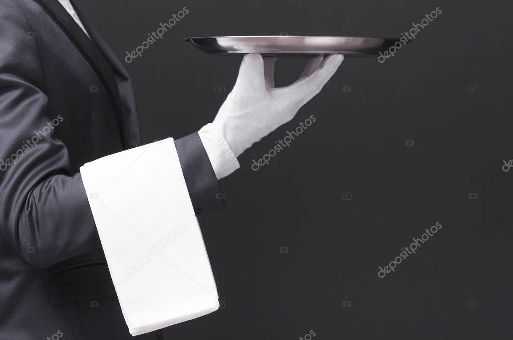Waiter holding a silver tray 