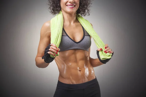 Fitness woman posing in green towel — Stock Photo, Image