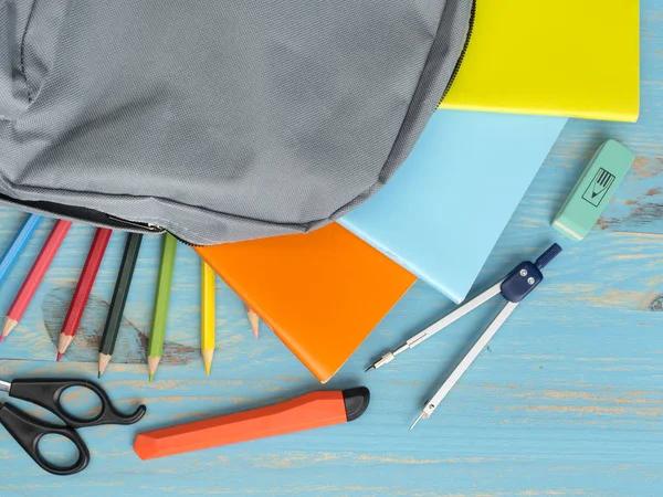 School backpack and supplies on table background — Stock Photo, Image