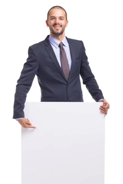 Fiatal üzletember, kezében egy fehér banner — Stock Fotó