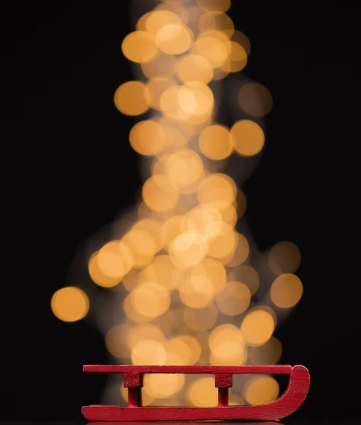 Red Christmas sleigh on blurred background — Stock Photo, Image