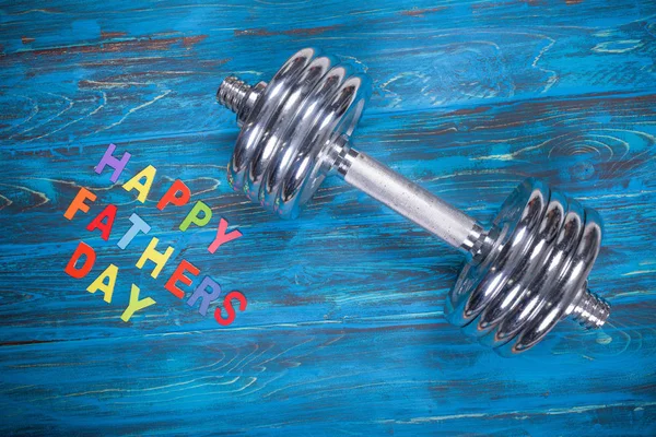 Happy Father Day Inscription Dumbbell Wooden Blue Background — стоковое фото
