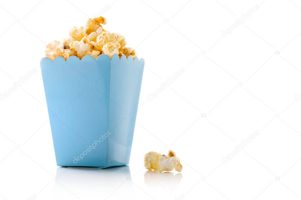 Popcorn in blue bucket on white background