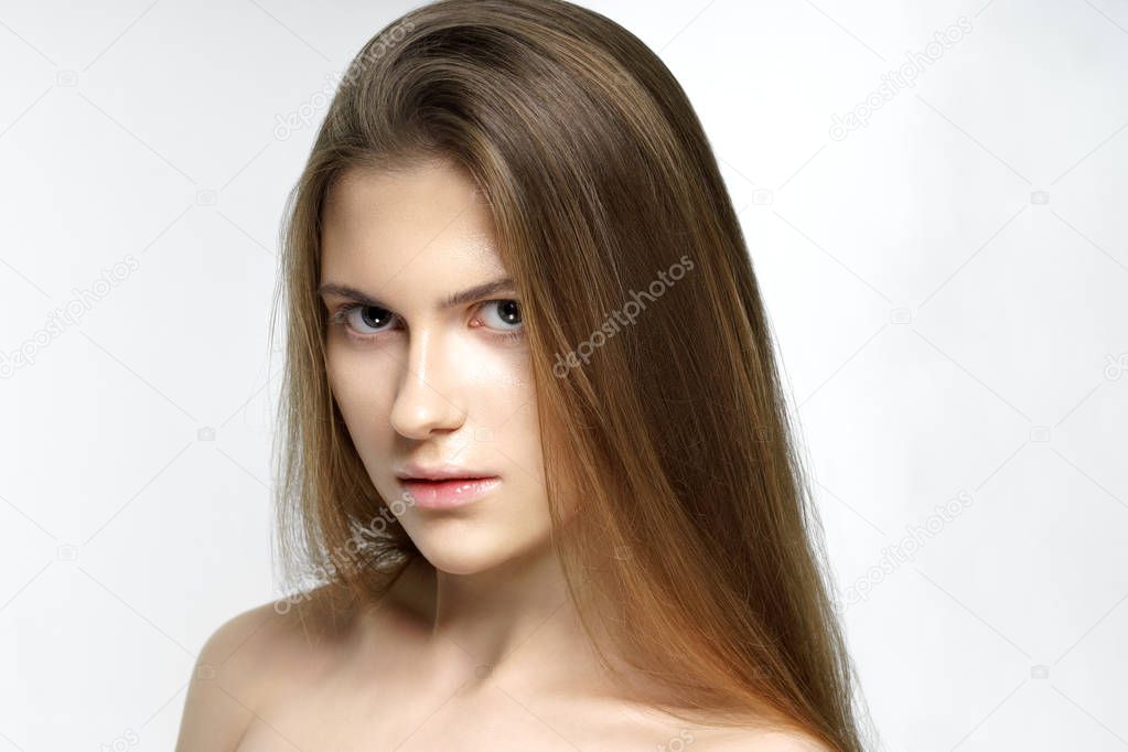 Studio shot of young beautiful woman with nude makeup