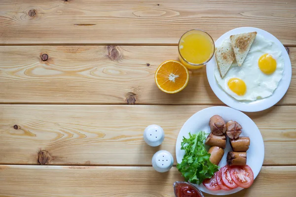 Orange juice, Two eggs and sausage for healthy breakfast. — Stock Photo, Image