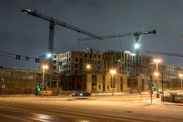 stock image Buildings under construction with cranes and illumination at dar