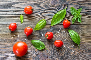 Ahşap masa arka plan üzerine kevgir içinde Fesleğenli domates. Gıda