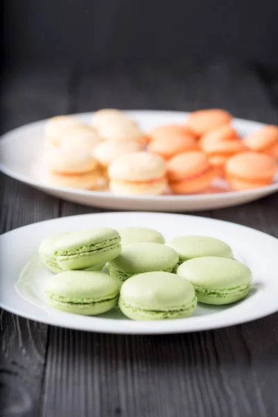 Green and orange colored French macaroons or macarons — Stock Photo, Image