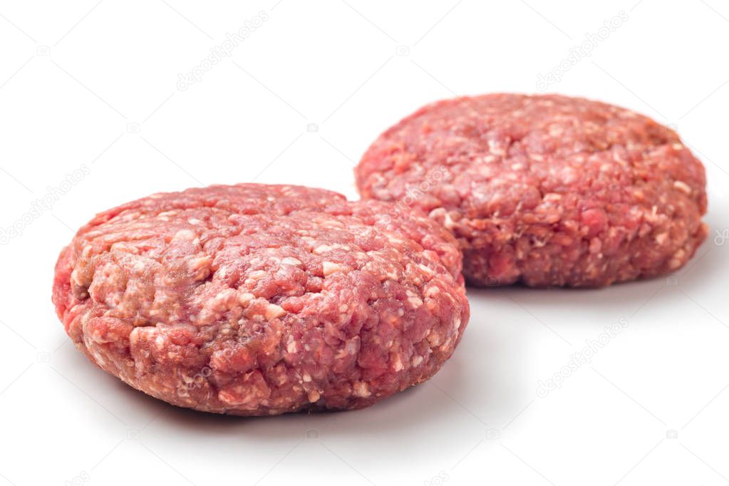 Two hamburger patties isolated on white background