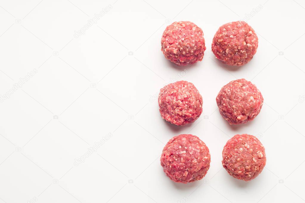 Meat balls from raw beef force-meat on a white