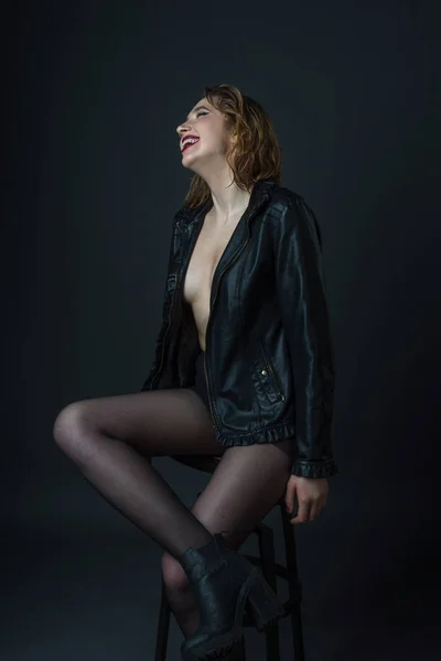 Fashion model wearing leather jacket posing on grey background — Stock Photo, Image