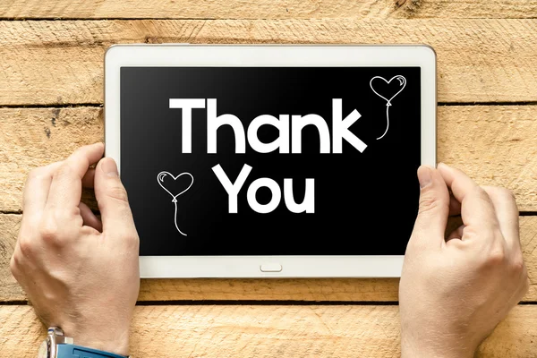 Thank you on tablet screen in hands — Stock Photo, Image
