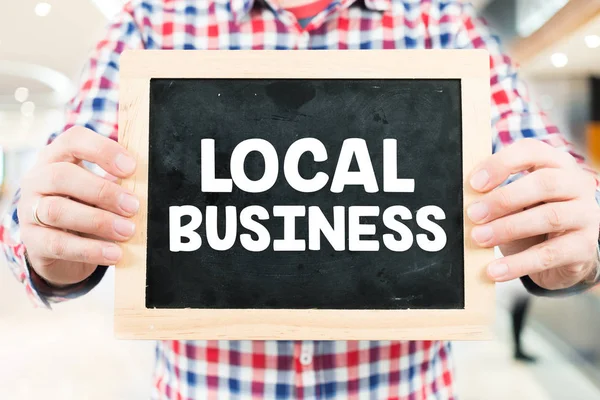 Man holding small blackboard — Stock Photo, Image