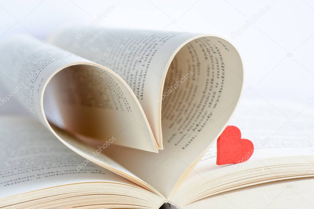 Opened book with heart form sheets