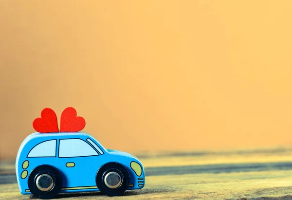 toy car delivering hearts for Valentine\'s day on background