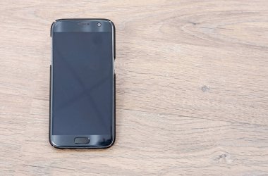 Ahşap arka planda akıllı telefon