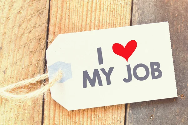 I love my job label on wooden table