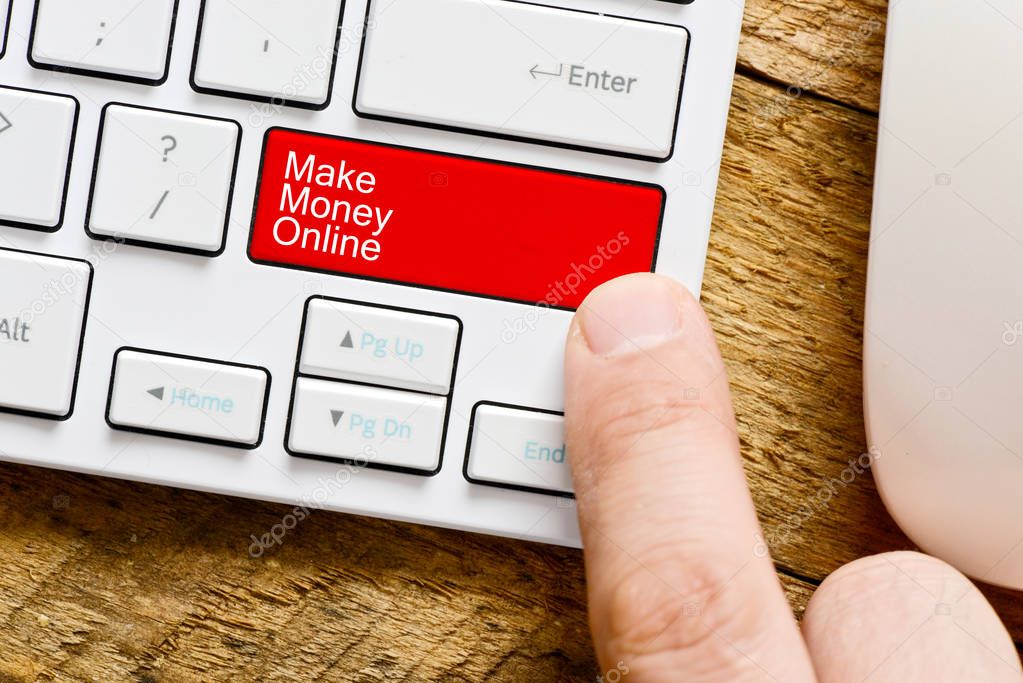 Make money online concept with text written on enter key of a white computer keyboard