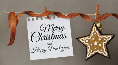 İpe asılmış bir kağıt parçasına ve Noel süslerine yazılmış mutlu Noeller. Noel zamanı - konsept. Yüksek çözünürlük.