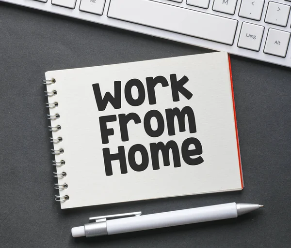 Work from home lettering written on notepad. Business concept.