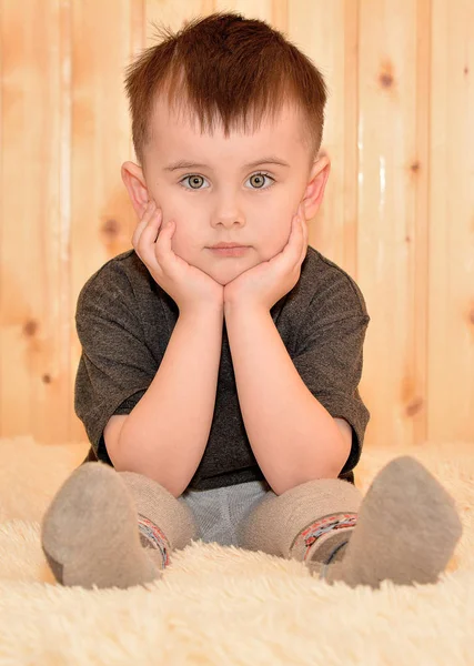 Serious Little Boy Sitting — Stock Photo, Image