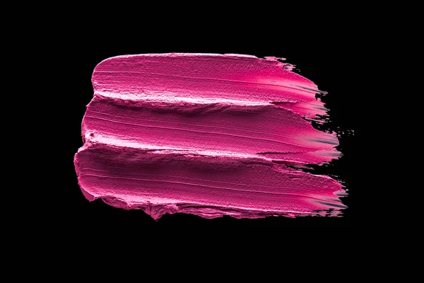 Smudged lipstick pink on a black isolated background — Stock Photo, Image