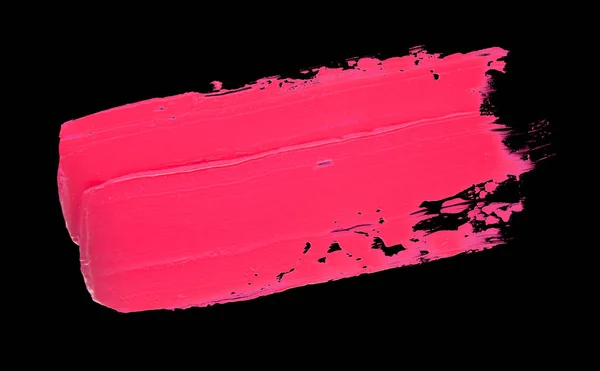 Lápiz labial manchado rosa sobre un fondo negro aislado —  Fotos de Stock